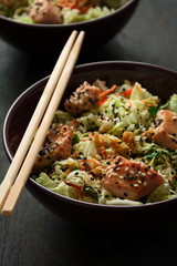 Fresh salad with napa cabbage, carrot, chicken, cilantro and sesame seeds