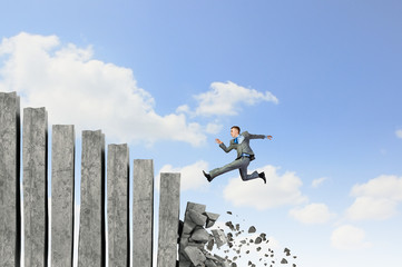 Businessman climbing stone ladder 