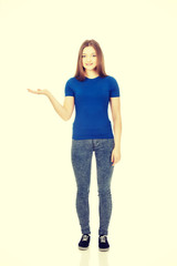 Smiling woman showing something on palm.