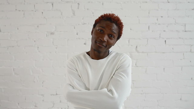 An insane black man in his forties wearing a straitjacket