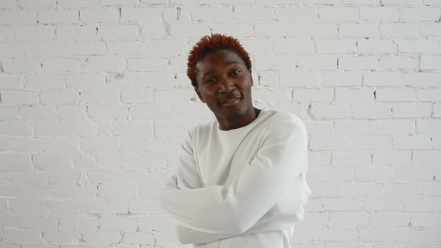 An insane black man in his forties wearing a straitjacket dance and try to get out