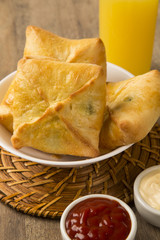 esfiha meat on the table with soda and orange juice