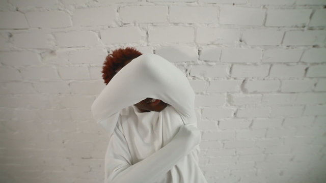 An insane black man in his forties wearing a straitjacket dance and try to get out