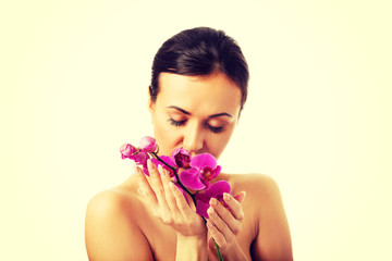 Obraz na płótnie Canvas Topless woman with purple orchid branch