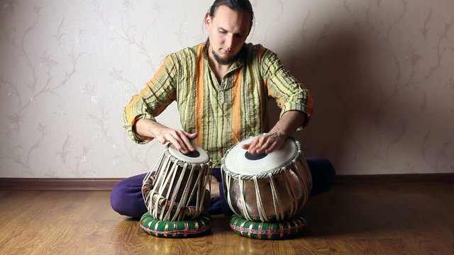 Man playing on Indian tabla drums 