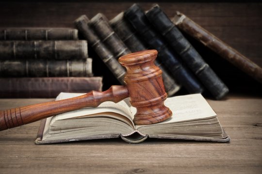 Wooden Judges Gavel And Old Law Books On Wooden Background