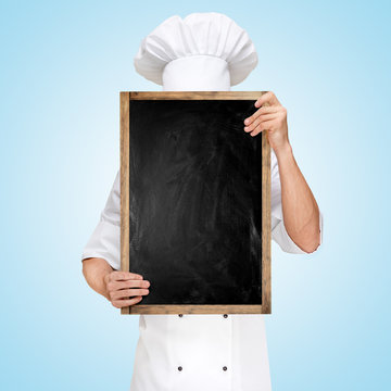 Menu chalkboard / Restaurant chef hiding behind a blank chalkboard for a business lunch menu with prices.