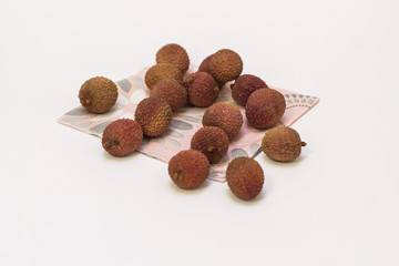 Lychees on a napkin, on the white background.