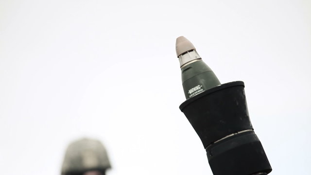 Close up shot of soldier firing a mortar.