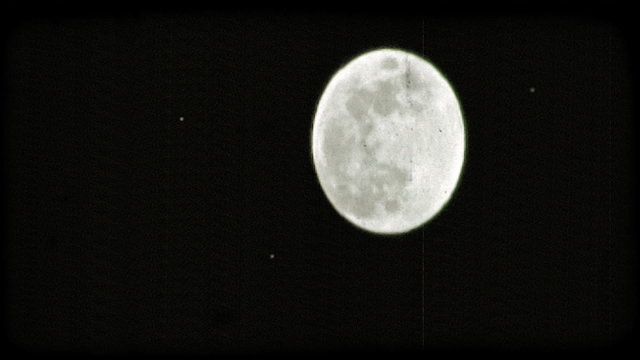Full moon in night sky. Vintage stylized video clip.