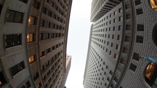 Upward fisheye view of skyscrapers while driving through San Francisco