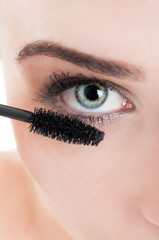 Woman applying mascara
