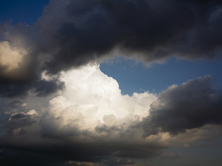 Dark and white clouds and blue sky