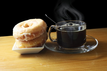 coffee cup with steam and donuts 