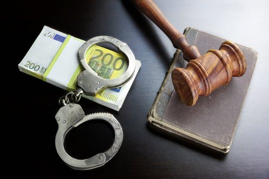 Judges Gavel, Handcuffs, Euro Cash And Book On  Black Table