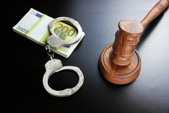 Judges Gavel, Handcuffs And Euro Cash  On The Black Table