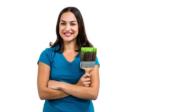 Portrait of smiling woman holding paint brush 