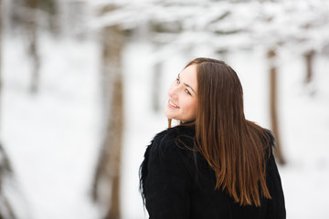 Young happy woman in winter park