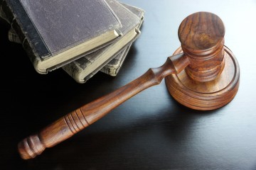 Judges Gavel And Old Book  On The Black Wooden Table