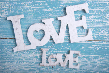 Word LOVE on old wooden background
