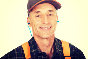 Mature worker wearing ear protectors