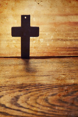 Old cross on a brown wood