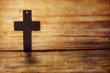 Old cross on a brown wood