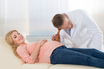 Fototapeta premium Doctor Listening To Heartbeat Of Fetus