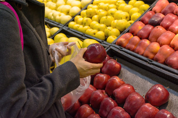 Women are choosing fruits in supermarket