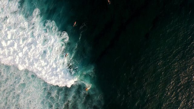 Aerial view of a surfer riding a wave in Bali, Indonesia