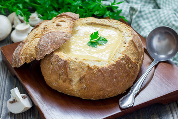 Homemade mushroom cream soup, served in bread bowl
