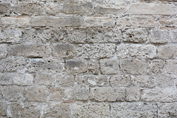 Gray, weathered stone blocks wall texture background
