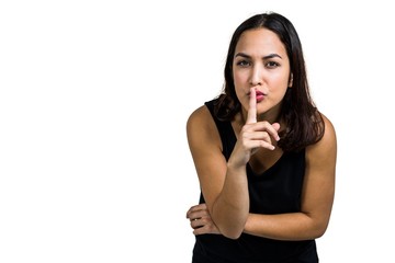 Portrait of woman with finger on lips