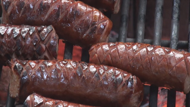 Extreme close up of grilling sausage on the fire pit