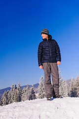 Fototapeta na wymiar Man stands on ski slope