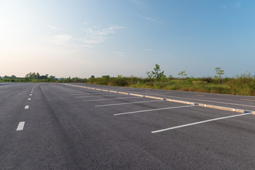 Fototapeta premium Empty parking lot against a beautiful blue sky