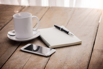 cup of coffee, notebook, pen and smart phone