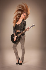 Fototapeta premium Beautiful girl playing guitar