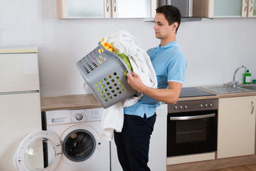 Man Carrying Heavy Laundry Basket