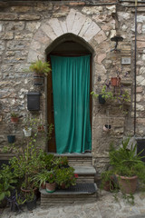 Fototapeta na wymiar Doors characteristic of the narrow streets of the ancient village of Spello, in Umbria (Italy)