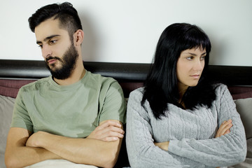 Unhappy couple after fight in bed not talking