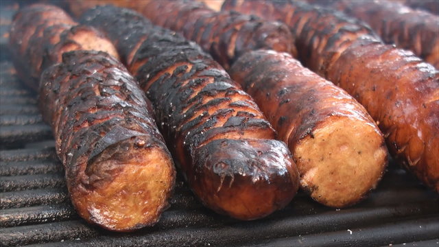 Close up of cut polish sausages on the fire pit's grill 2