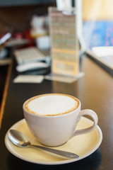 Coffee cup on wooden table in coffee shop