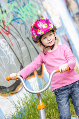 Obraz premium little girl with a scooter