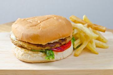 burger with french fries on wooden background