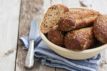 Protein bread (without flour) with linseeds, sunflower seeds and sesame seeds in wooden bowl. Selective focus. Natural light.
