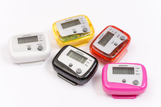 Colorful pedometers over white background