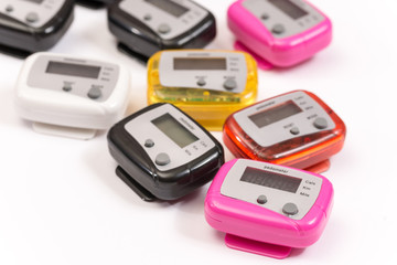 Colorful pedometers over white background