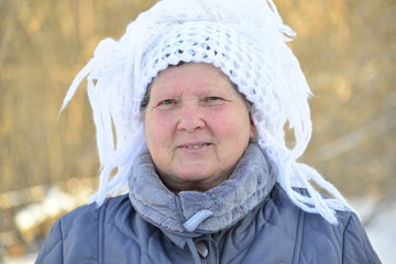 elderly woman in  white knitted shawl on her head 