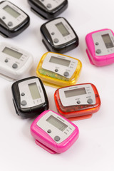 Colorful pedometers over white background